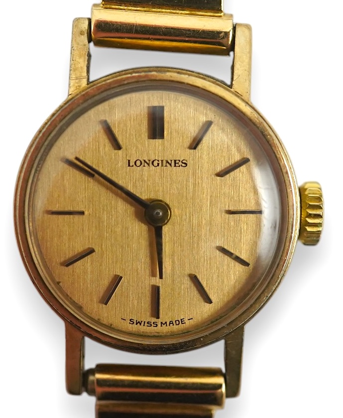 A lady's modern 9ct gold Longines manual wind wrist watch, on an Italian 18k gold bracelet